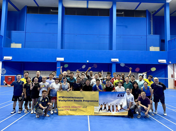 Participants posing with the STMicroelectronics banner on court